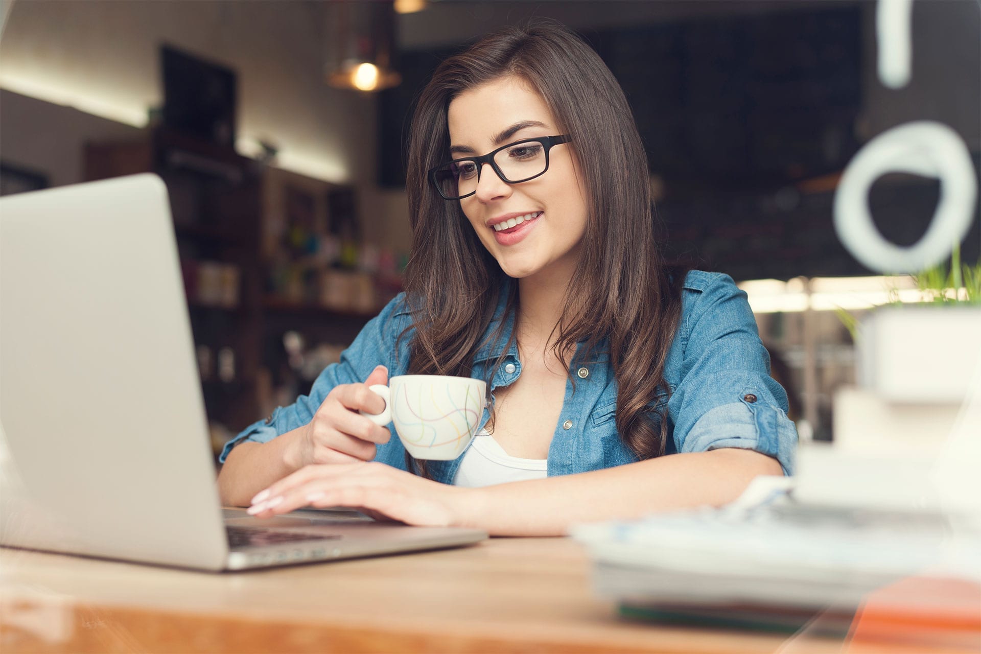 Smiling woman using laptop to run an online business